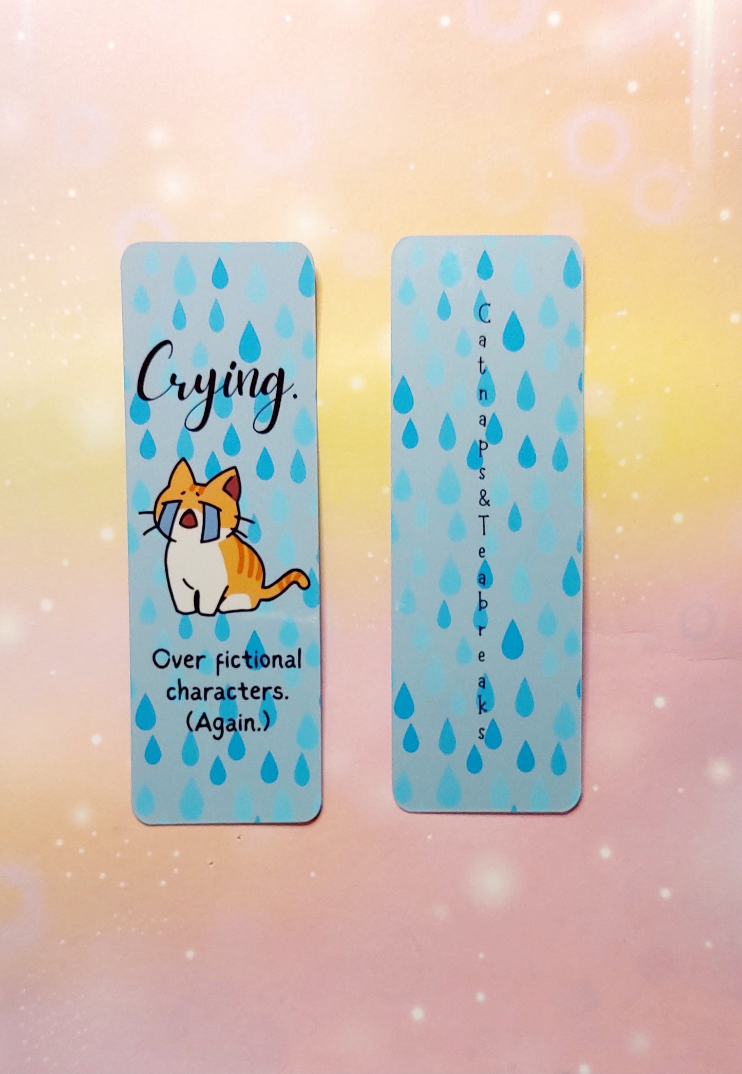Funny bookmark cat crying over fictional characters
