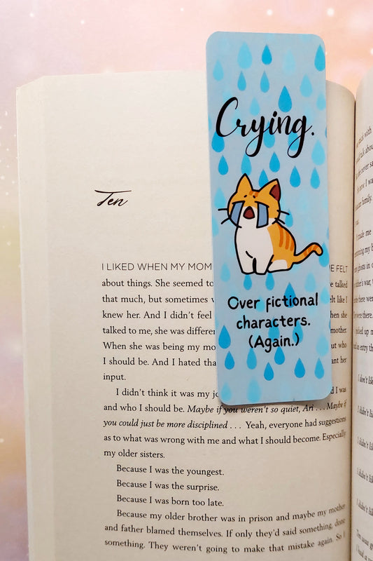 Funny bookmark cat crying over fictional characters